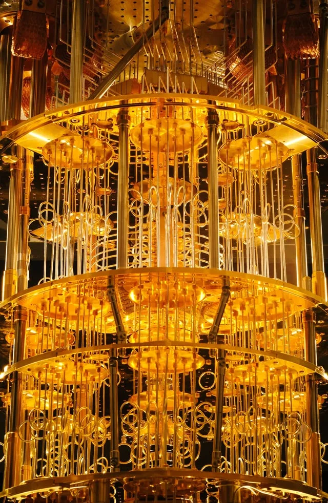 A quantum computer, often housed in a distinctive gold-plated dilution refrigerator, operates at tem