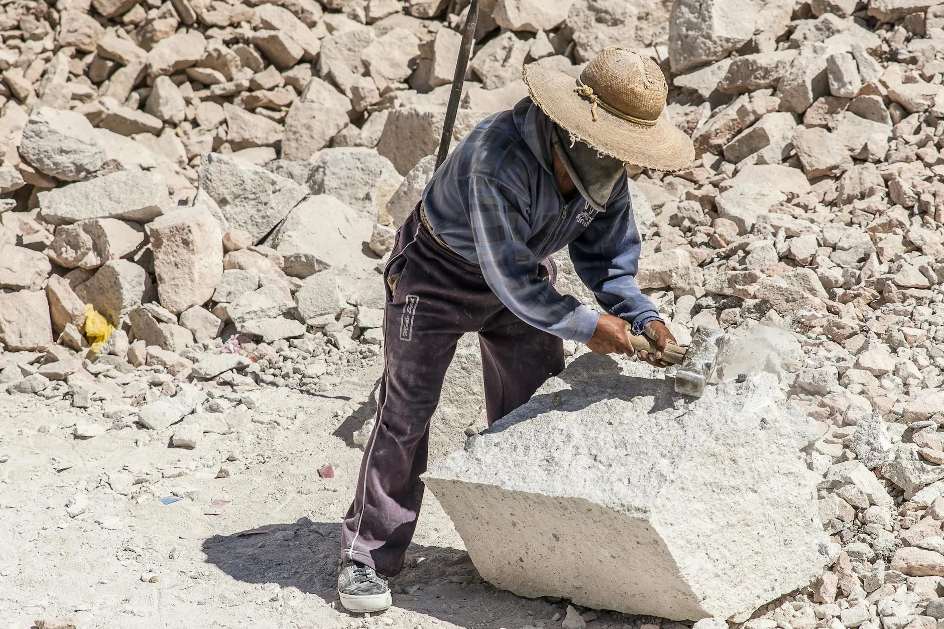 Indian workers quarrying quartz in Rajasthan, dusty conditions.